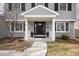 The front door is framed by columns and brick, providing a welcoming entrance to the home at 6869 S Niagara Ct, Centennial, CO 80112