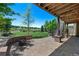 Spacious backyard featuring a brick patio, fire pit, green lawn, and scenic golf course views at 12015 Blackwell Way, Parker, CO 80138