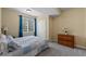 Comfortable bedroom with natural light, featuring a window, closet, carpet, and a wooden dresser at 12015 Blackwell Way, Parker, CO 80138