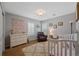 Serene bedroom with a white crib, dresser, and fluffy rug, perfect for relaxation at 12015 Blackwell Way, Parker, CO 80138