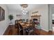 Elegant dining room featuring hardwood floors, a stone fireplace, and a unique chandelier at 12015 Blackwell Way, Parker, CO 80138