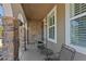 Charming front porch featuring stone columns and comfortable seating, perfect for relaxing and enjoying the outdoors at 12015 Blackwell Way, Parker, CO 80138