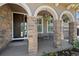 Inviting front porch with stone columns, comfortable seating, and decorative hanging flower baskets at 12015 Blackwell Way, Parker, CO 80138