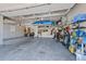 Spacious garage with ample storage, featuring an overhead rack and organizational systems for tools and equipment at 12015 Blackwell Way, Parker, CO 80138