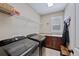 Functional laundry room with front loading machines, a sink, and ample storage space at 12015 Blackwell Way, Parker, CO 80138