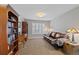 Cozy office with built in bookshelf, hardwood desk, and a comfortable leather couch at 12015 Blackwell Way, Parker, CO 80138