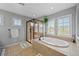 Bright bathroom boasts a large soaking tub, glass enclosed shower and plantation shutters at 12015 Blackwell Way, Parker, CO 80138