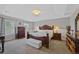 Elegant main bedroom featuring a large bed, dresser, and ample natural light from windows at 12015 Blackwell Way, Parker, CO 80138