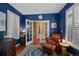 Comfortable home office showcasing blue walls, hardwood floors, and ample seating, perfect for remote work at 12015 Blackwell Way, Parker, CO 80138