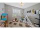Bright playroom with toys, a playhouse, and ample natural light through the window at 12015 Blackwell Way, Parker, CO 80138