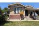 A brick two-story home features a combination brick and stone front and well maintained lawn at 1415 Raleigh St, Denver, CO 80204