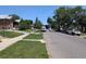 Wide angle residential street view of neighborhood with single-Gathering homes and mature trees at 1415 Raleigh St, Denver, CO 80204
