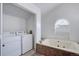 Spacious bathroom with both a washer/dryer and a luxurious sunken tub, providing ultimate convenience at 11115 E Alameda Ave # 201, Aurora, CO 80012