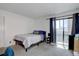 Bedroom includes a queen bed, access to outside porch, and natural light at 11115 E Alameda Ave # 201, Aurora, CO 80012