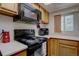 Equipped kitchen with a stove, microwave, and ample cabinet space, ideal for home cooking at 11115 E Alameda Ave # 201, Aurora, CO 80012