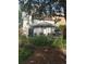 The house has a large backyard with a canopy covering a sitting area and lots of plants at 36 N Logan St, Denver, CO 80203