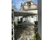 The house has a quaint backyard with a canopy covering a stone tiled patio and a variety of greenery at 36 N Logan St, Denver, CO 80203