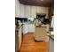 Efficient kitchen with white cabinets, a central island, and modern appliances at 36 N Logan St, Denver, CO 80203