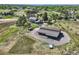 Aerial view of a property featuring a home, barn, and expansive acreage, perfect for outdoor activities at 6646 S Fundy Ct, Centennial, CO 80016