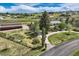 Sprawling property featuring home, large barn, mature trees and landscaping, fenced yard and circular driveway at 6646 S Fundy Ct, Centennial, CO 80016
