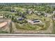 Aerial shot of a property with a home, barn, and a large open field, providing a picturesque rural setting at 6646 S Fundy Ct, Centennial, CO 80016