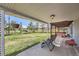 Relaxing backyard patio with comfortable seating, a hot tub, and scenic views of the expansive grassy yard at 6646 S Fundy Ct, Centennial, CO 80016