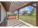 Backyard covered patio showcasing a relaxing hot tub with pergola and a vast lawn under a sunny sky at 6646 S Fundy Ct, Centennial, CO 80016