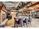 Unique bar with seating and fireplace with a view into the kitchen at 6646 S Fundy Ct, Centennial, CO 80016