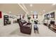 Large open basement with a brown leather reclining sofa, a desk, and entertainment area at 6646 S Fundy Ct, Centennial, CO 80016
