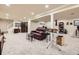 Spacious carpeted basement with a comfortable brown leather sofa, a staircase and recessed lighting at 6646 S Fundy Ct, Centennial, CO 80016