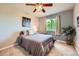 Bright bedroom with a neutral color scheme, a ceiling fan, and a large window at 6646 S Fundy Ct, Centennial, CO 80016