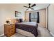 Comfortable bedroom with a ceiling fan, carpet, and a window offering natural light at 6646 S Fundy Ct, Centennial, CO 80016