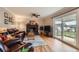 Cozy living room featuring a brick fireplace, hardwood floors, and sliding glass doors to the outside at 6646 S Fundy Ct, Centennial, CO 80016