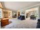 Spacious living room flows into the dining room, featuring neutral paint and lots of natural light at 6646 S Fundy Ct, Centennial, CO 80016