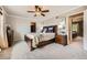 Spacious main bedroom with a walk-in closet, ceiling fan, and neutral-toned carpet at 6646 S Fundy Ct, Centennial, CO 80016