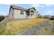 Cozy home's backyard with healthy lawn and a nice patio area perfect for relaxing at 806 Peony Ct, Brighton, CO 80601
