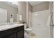 Inviting bathroom with a tiled tub-shower combo and a dark vanity with good lighting at 806 Peony Ct, Brighton, CO 80601