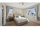Bright bedroom featuring two large windows and neutral décor at 806 Peony Ct, Brighton, CO 80601