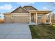 Charming, single-Gathering home with a two-car garage, stone accents, and manicured lawn at 806 Peony Ct, Brighton, CO 80601