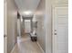 Bright hallway with wood-look flooring, modern lighting, and neutral paint at 806 Peony Ct, Brighton, CO 80601