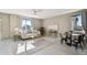 Bright living room with lots of light, neutral decor, and modern ceiling fan at 806 Peony Ct, Brighton, CO 80601