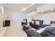 Finished basement featuring ample seating, coffee table, and a wet bar area at 32 Eagle Dr, Littleton, CO 80123