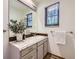 Elegant bathroom vanity with granite countertops, stylish decor, and a well-lit mirror at 32 Eagle Dr, Littleton, CO 80123