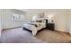 Bright bedroom with a large window, plush carpet, and a comfortable king-size bed at 32 Eagle Dr, Littleton, CO 80123
