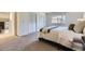 Comfortable bedroom featuring soft carpet, closet doors, and a view to the entry at 32 Eagle Dr, Littleton, CO 80123