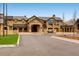 Grand stone exterior elevation of this building with porte cochere and manicured landscaping at 32 Eagle Dr, Littleton, CO 80123