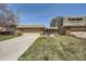 Charming brick home showcasing a well-manicured lawn and attached two-car garage at 32 Eagle Dr, Littleton, CO 80123