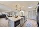 Bright, modern kitchen featuring a large island, skylight and open to the dining and living areas, perfect for entertaining at 32 Eagle Dr, Littleton, CO 80123