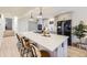 Modern kitchen with a large island, stylish bar stools, and updated appliances, perfect for cooking and casual dining at 32 Eagle Dr, Littleton, CO 80123