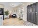 Cozy living room featuring an accent chair, stylish decor, and light wood floors near the entry at 32 Eagle Dr, Littleton, CO 80123